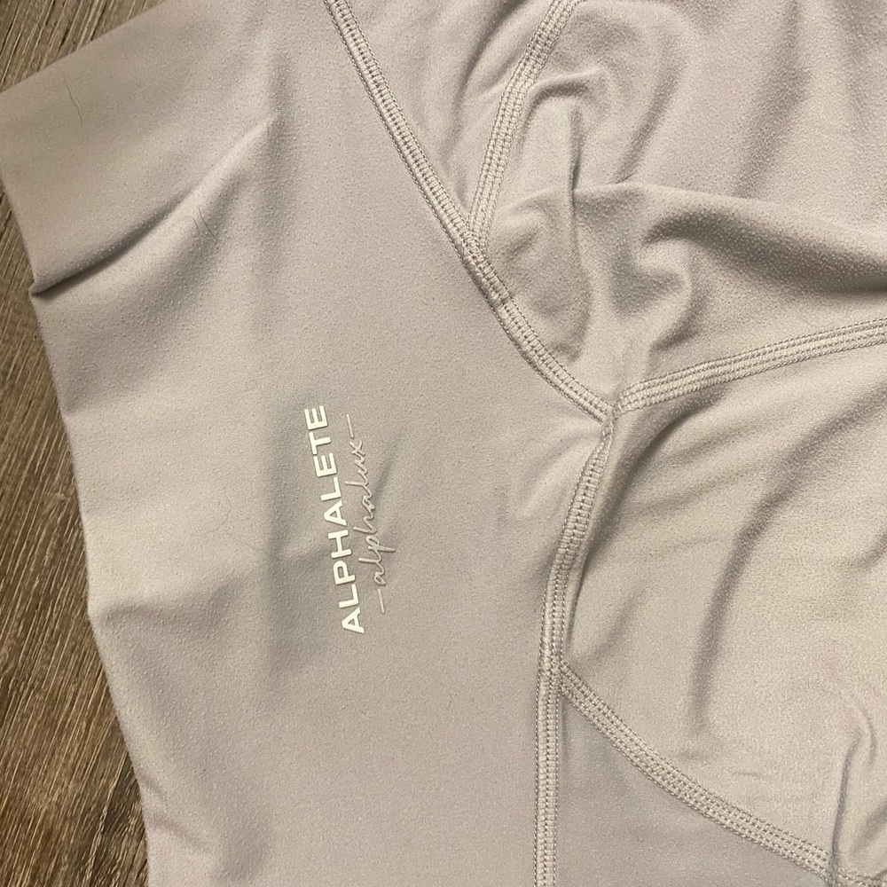 Alphalete “Alphalux” light gray leggings.